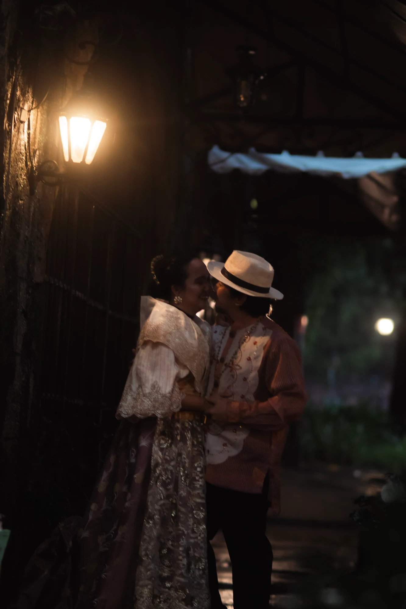 Clive and Rubie sharing a quiet moment beneath a glowing lantern