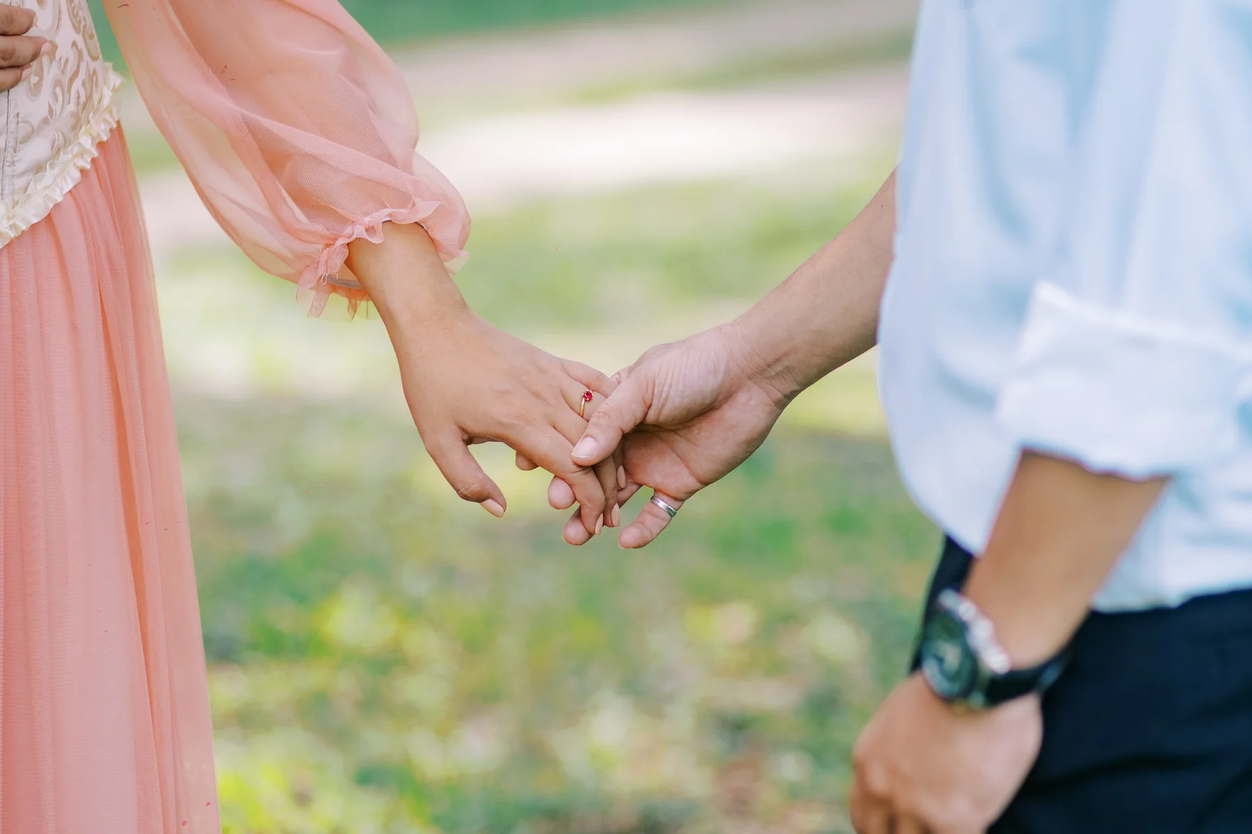A close-up of their hands held together