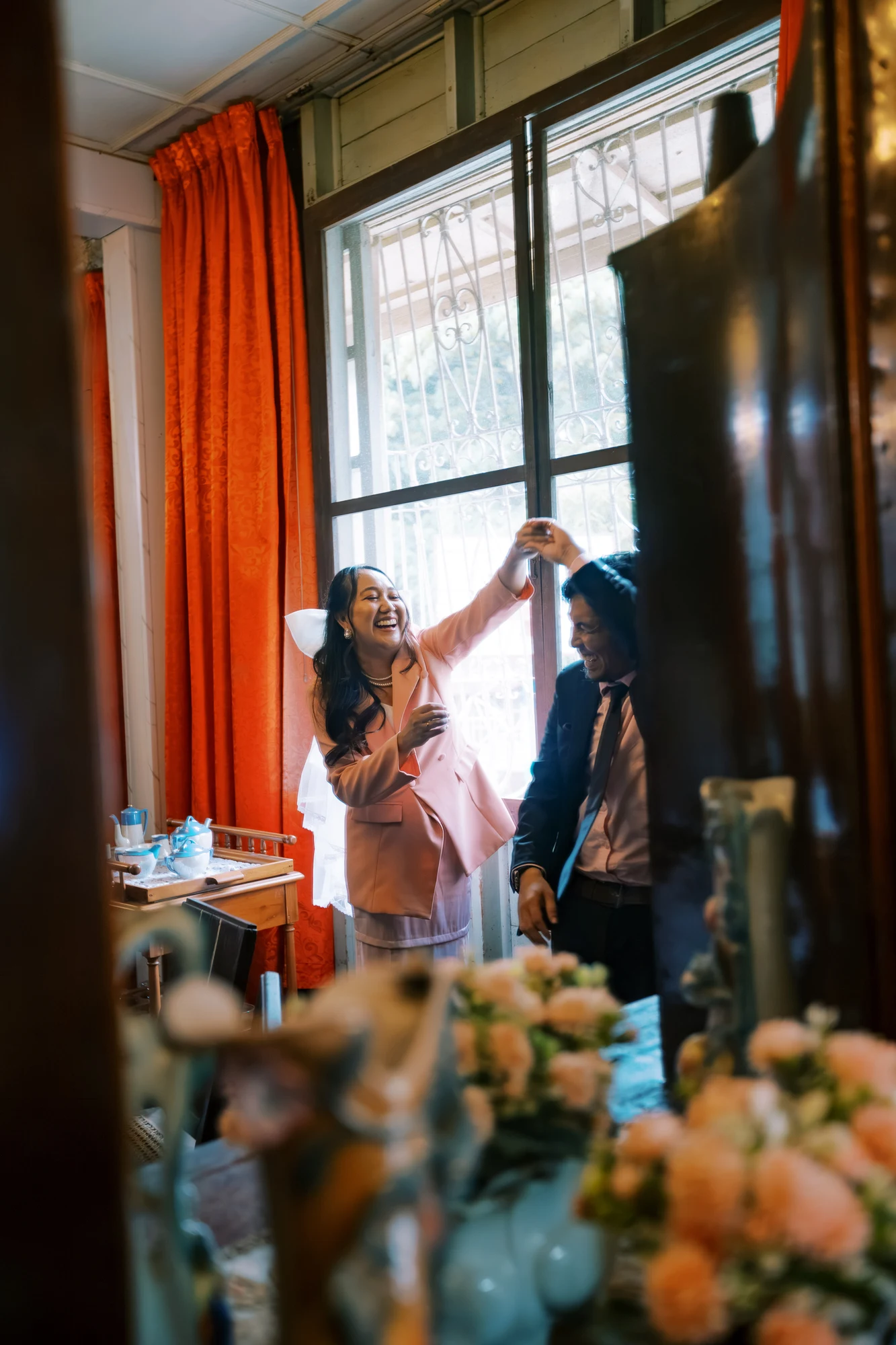 Clive and Rubie dancing beside a sunlit heritage window